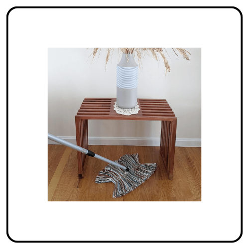 A Sladust Big Wooly dust mop featuring multi-colored natural wool fibers, a swivel head, and a sturdy wooden handle on a hardwood floor.